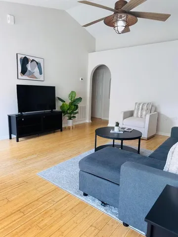 a living room with furniture and a flat screen tv