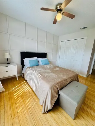 a bedroom with a bed and wooden floor