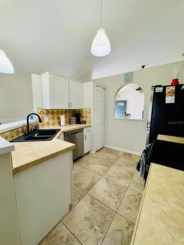 a kitchen with a sink appliances and cabinets
