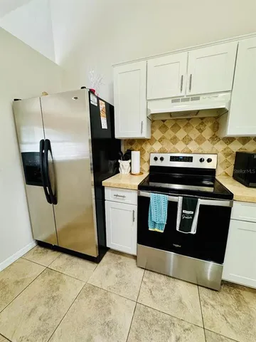 a kitchen with appliances and cabinets