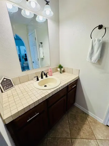 a bathroom with a sink vanity and mirror