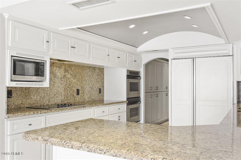 4438 East Camelback Road, Unit 143 Phoenix, AZ 85018 - Photo 13 of 30 a kitchen with stainless steel appliances granite countertop a refrigerator and a stove