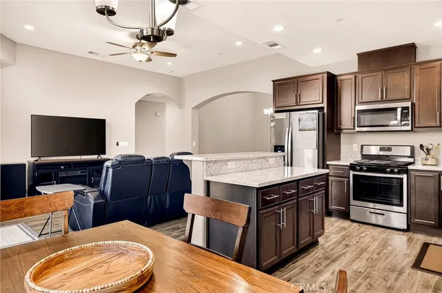 a kitchen with stainless steel appliances and wooden cabinets