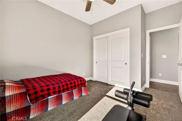 a bathroom with a granite countertop sink toilet and a mirror