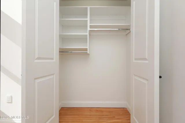 a bathroom with a tub a sink and mirror