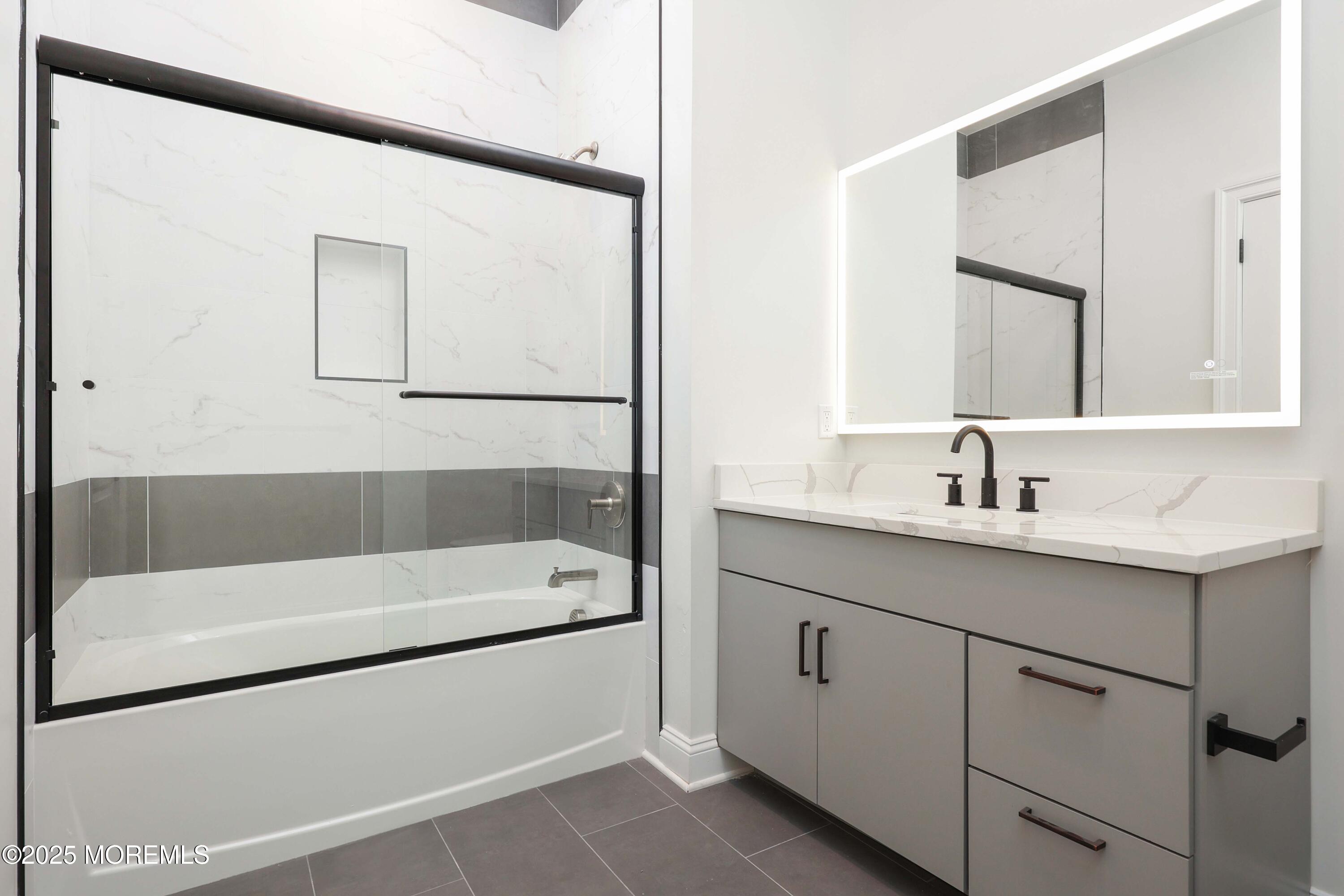 179 Chelsea Avenue, Unit 210 Long Branch, NJ 07740 - Photo 17 of 22 a bathroom with a tub a sink and mirror