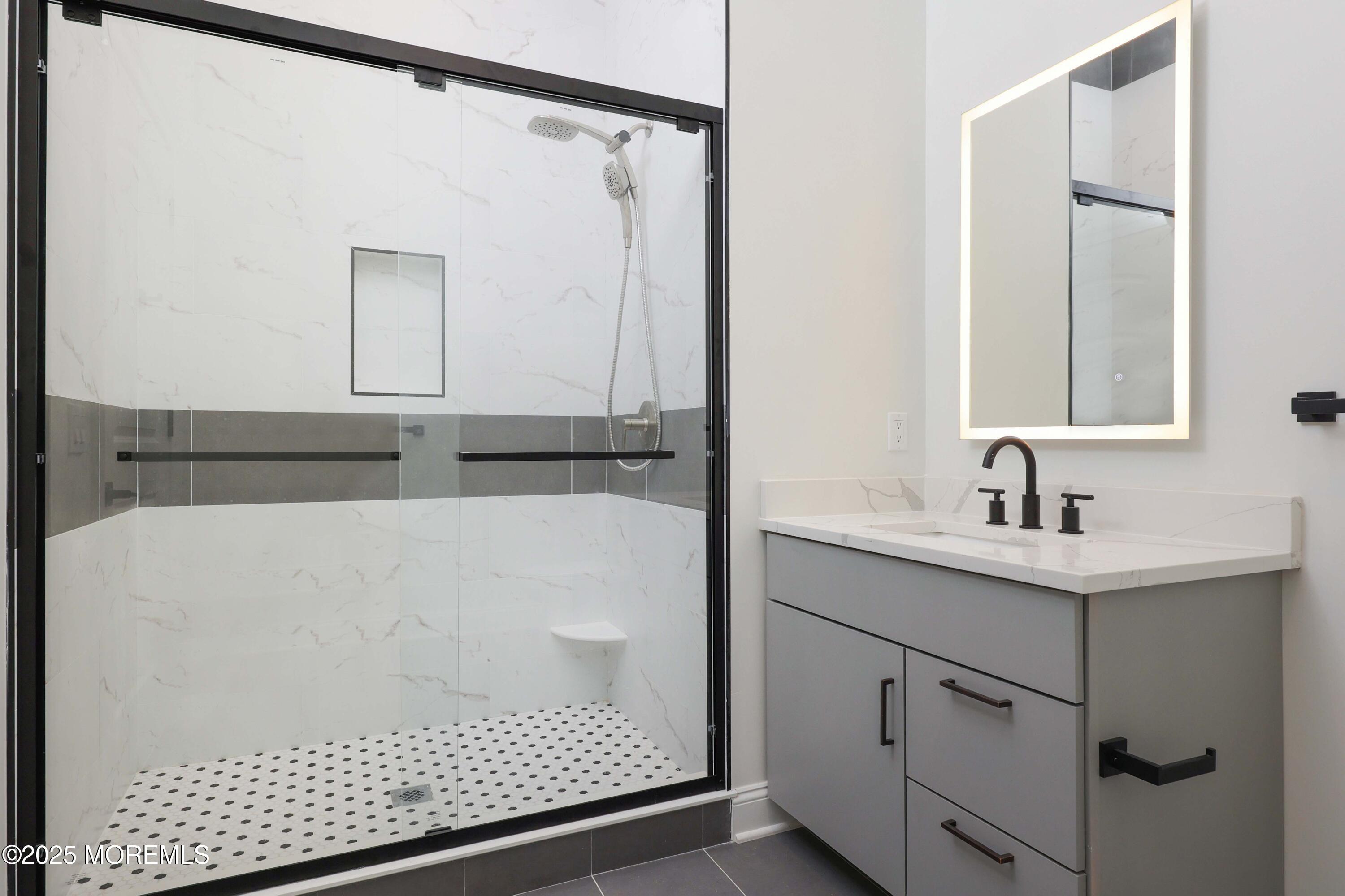 179 Chelsea Avenue, Unit 210 Long Branch, NJ 07740 - Photo 20 of 22 a bathroom with a sink and a mirror