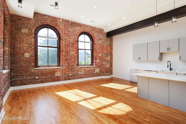 a view of a kitchen with a sink and cabinets