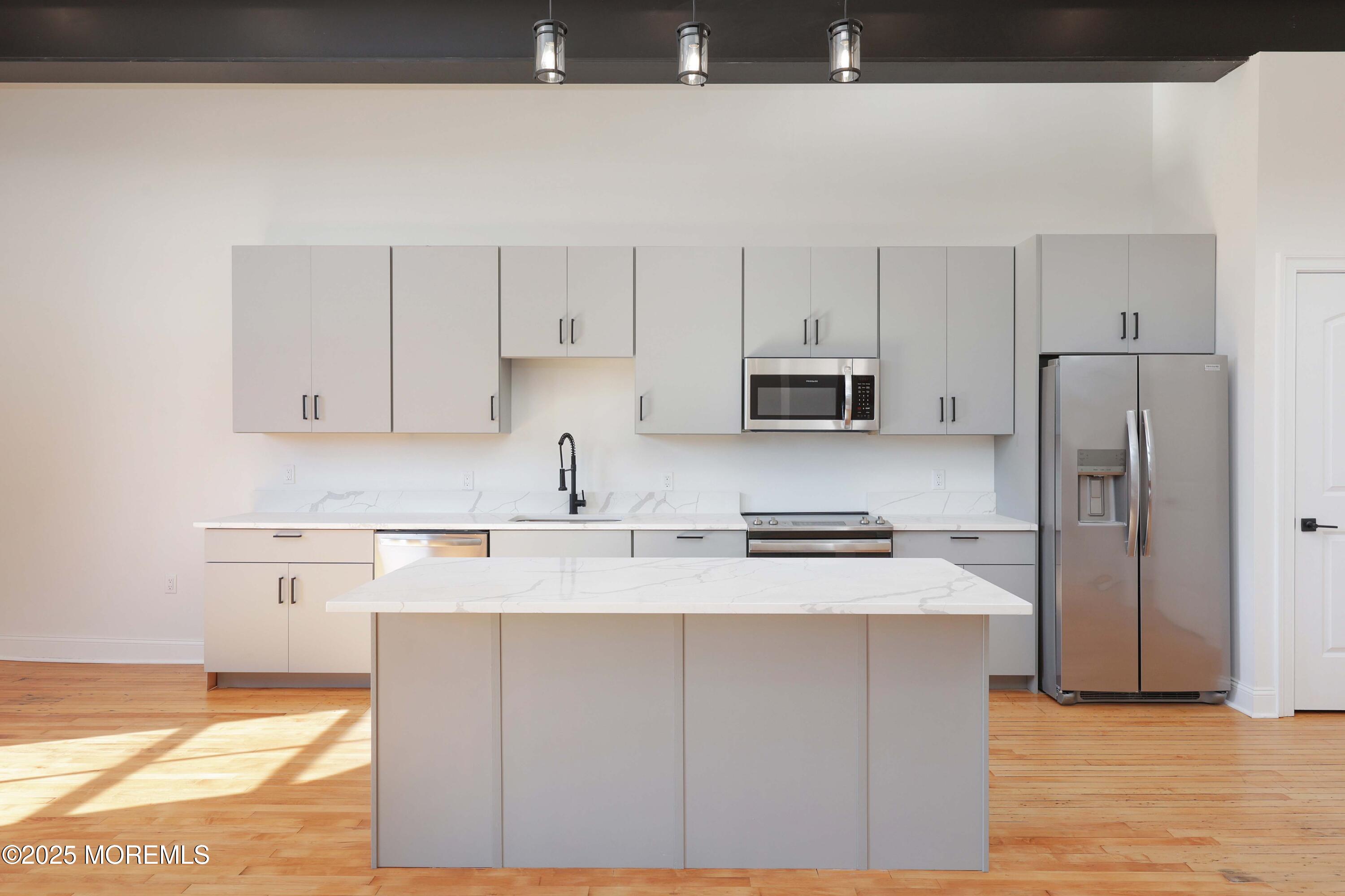 179 Chelsea Avenue, Unit 210 Long Branch, NJ 07740 - Photo 9 of 22 a kitchen with stainless steel appliances granite countertop a sink stove and refrigerator