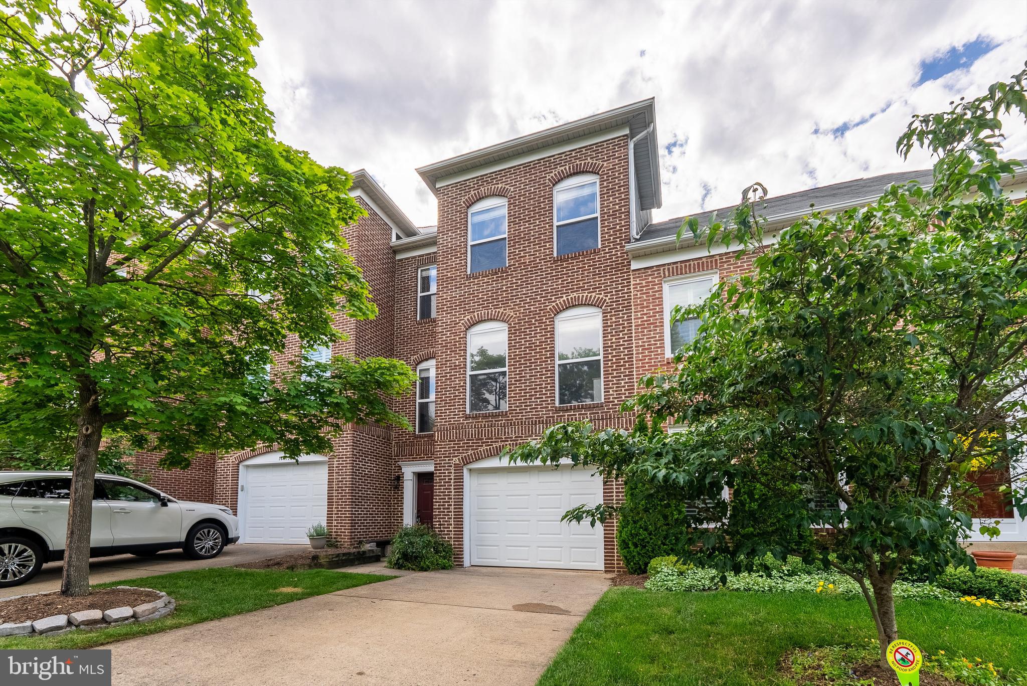 12081 Edgemere Circle Reston, VA 20190 - Photo 1 of 36 a front view of a house with a yard and garage