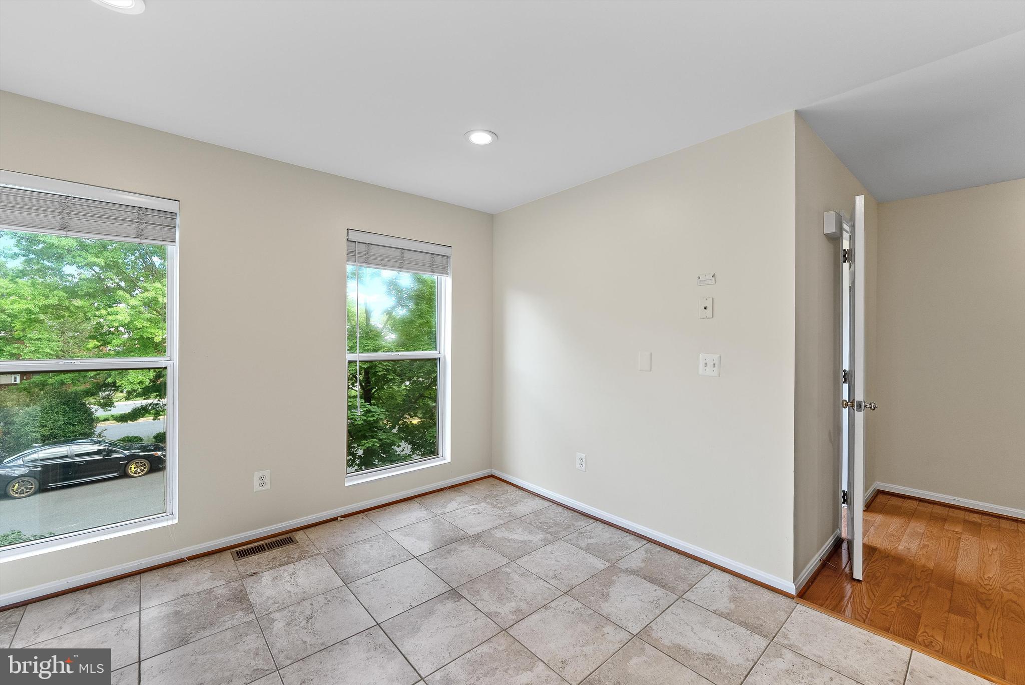 12081 Edgemere Circle Reston, VA 20190 - Photo 11 of 36 a view of an empty room with wooden floor and a window