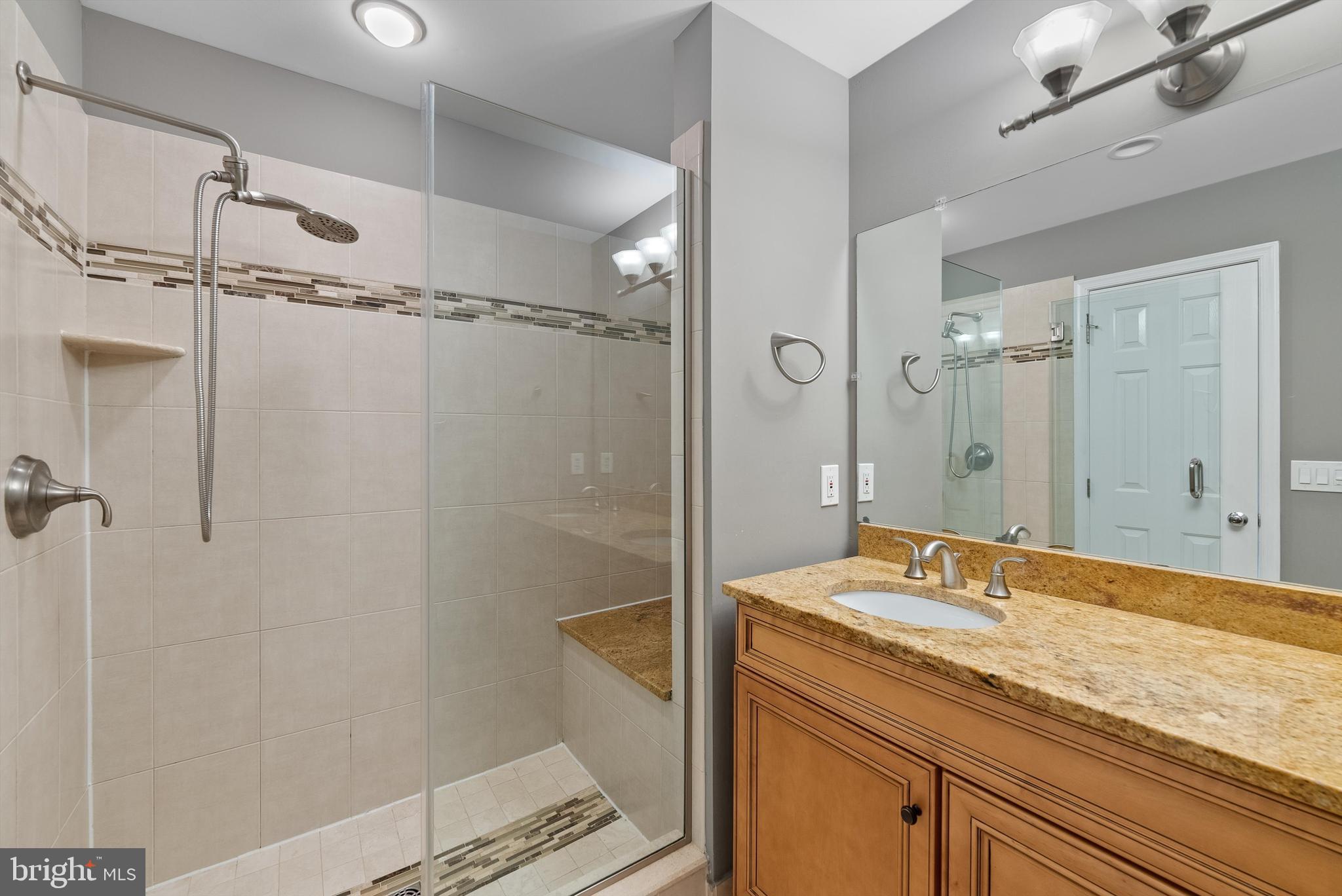 12081 Edgemere Circle Reston, VA 20190 - Photo 18 of 36 a bathroom with a granite countertop sink shower and a mirror