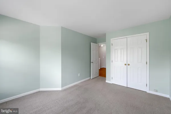 a view of an empty room and closet area