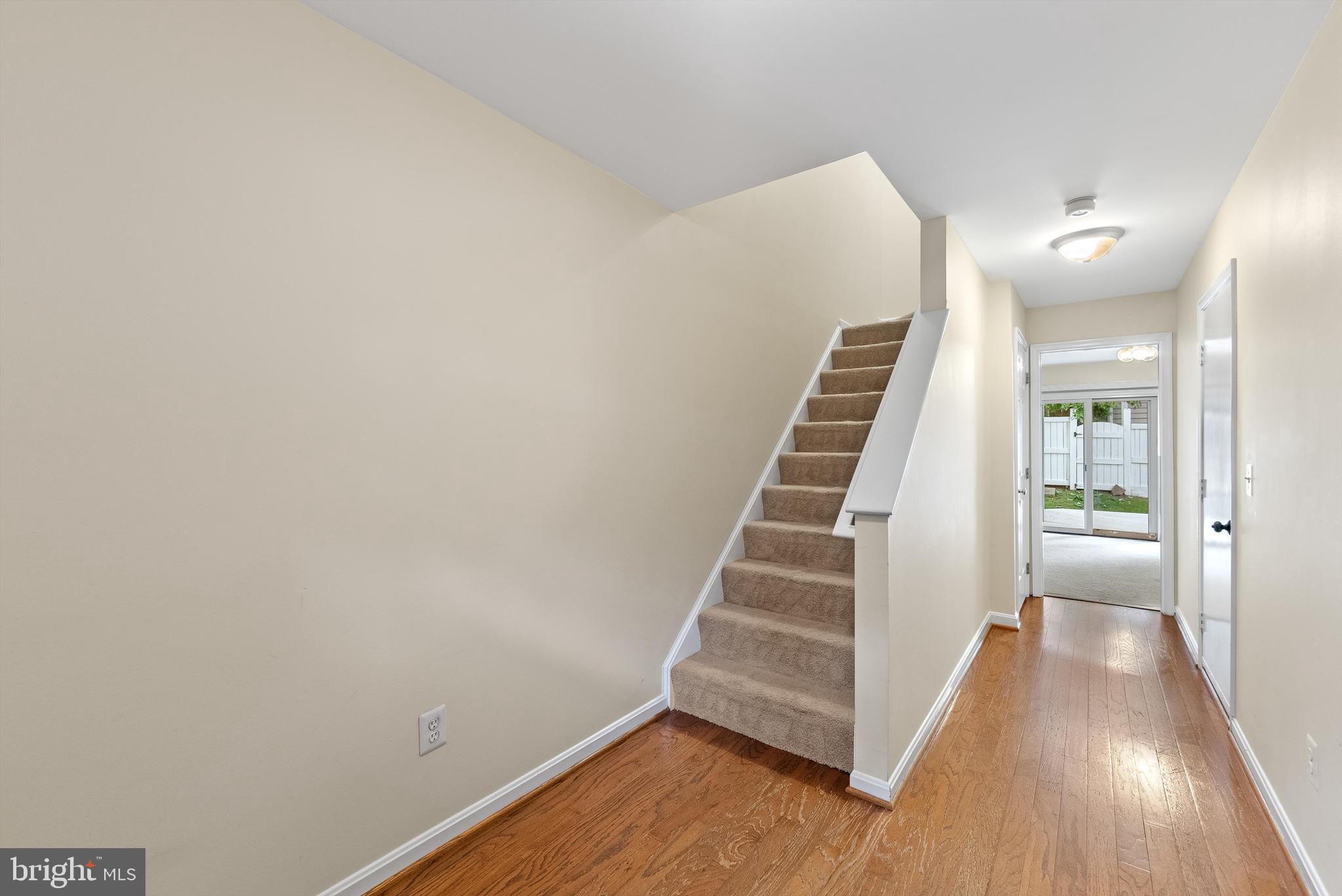 12081 Edgemere Circle Reston, VA 20190 - Photo 26 of 36 a view of a hallway with wooden floor and stairs
