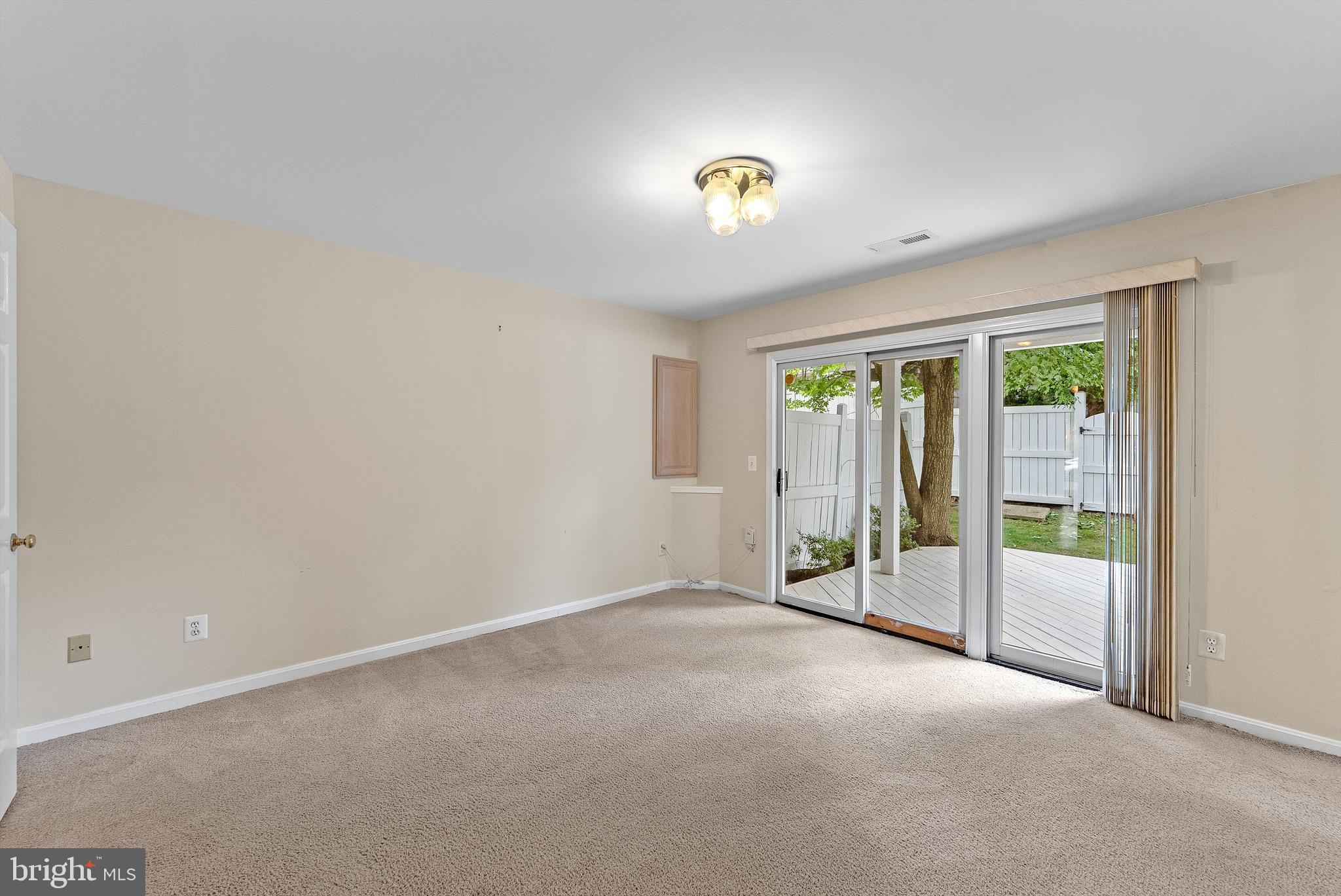 12081 Edgemere Circle Reston, VA 20190 - Photo 28 of 36 an empty room with sliding glass door and windows