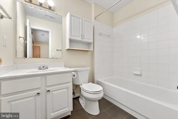 a bathroom with a sink toilet vanity and tub
