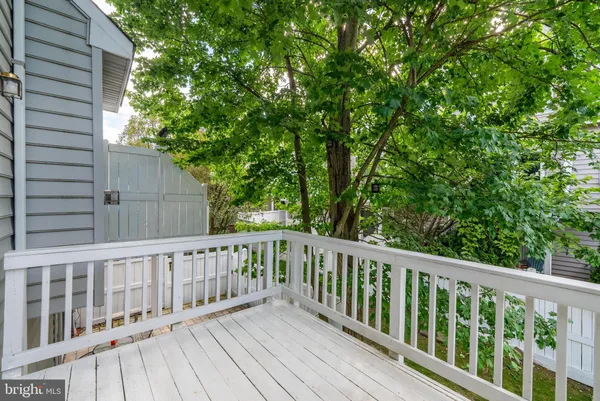 a view of wooden deck and a backyard