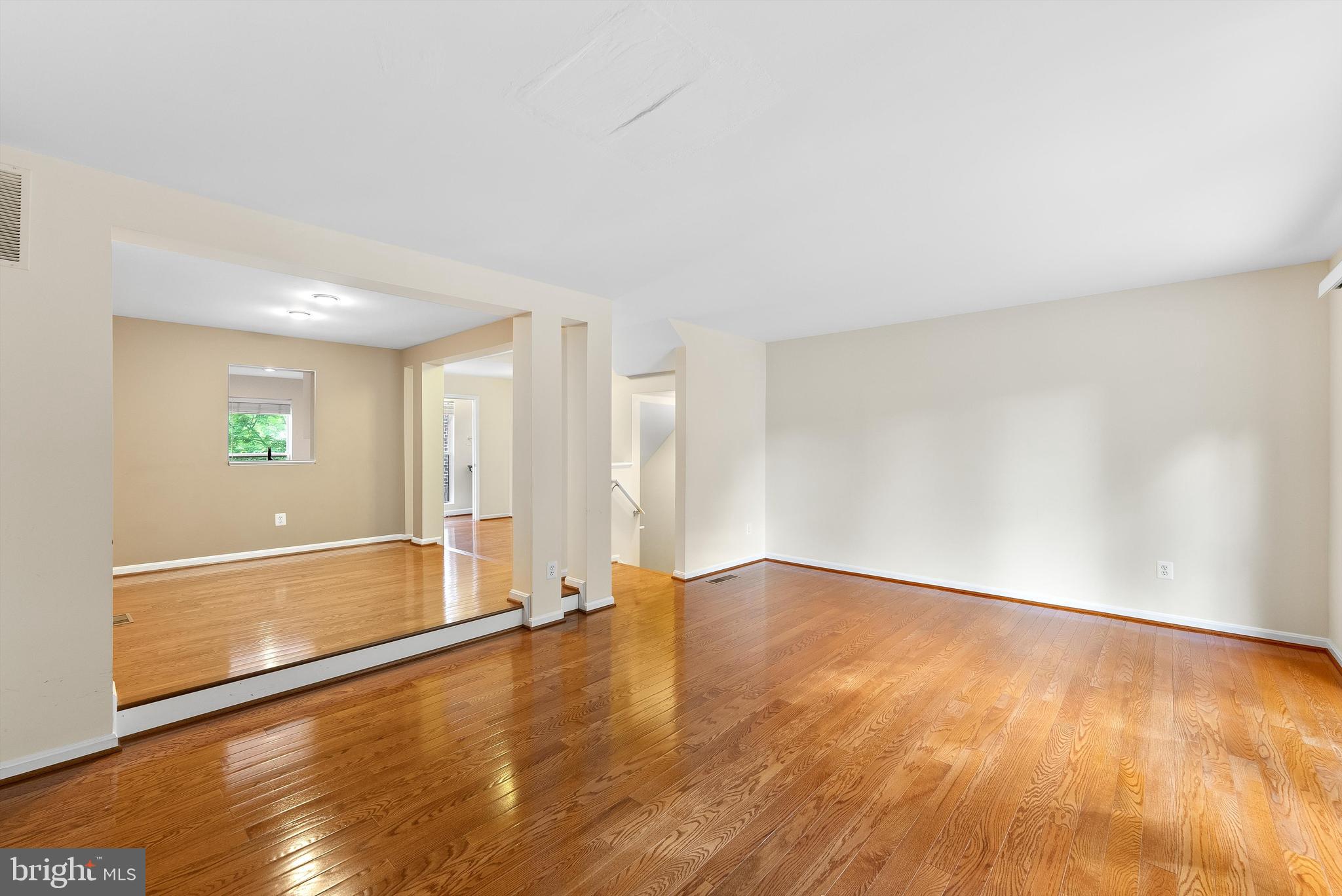 12081 Edgemere Circle Reston, VA 20190 - Photo 5 of 36 a view of an empty room with wooden floor and a window