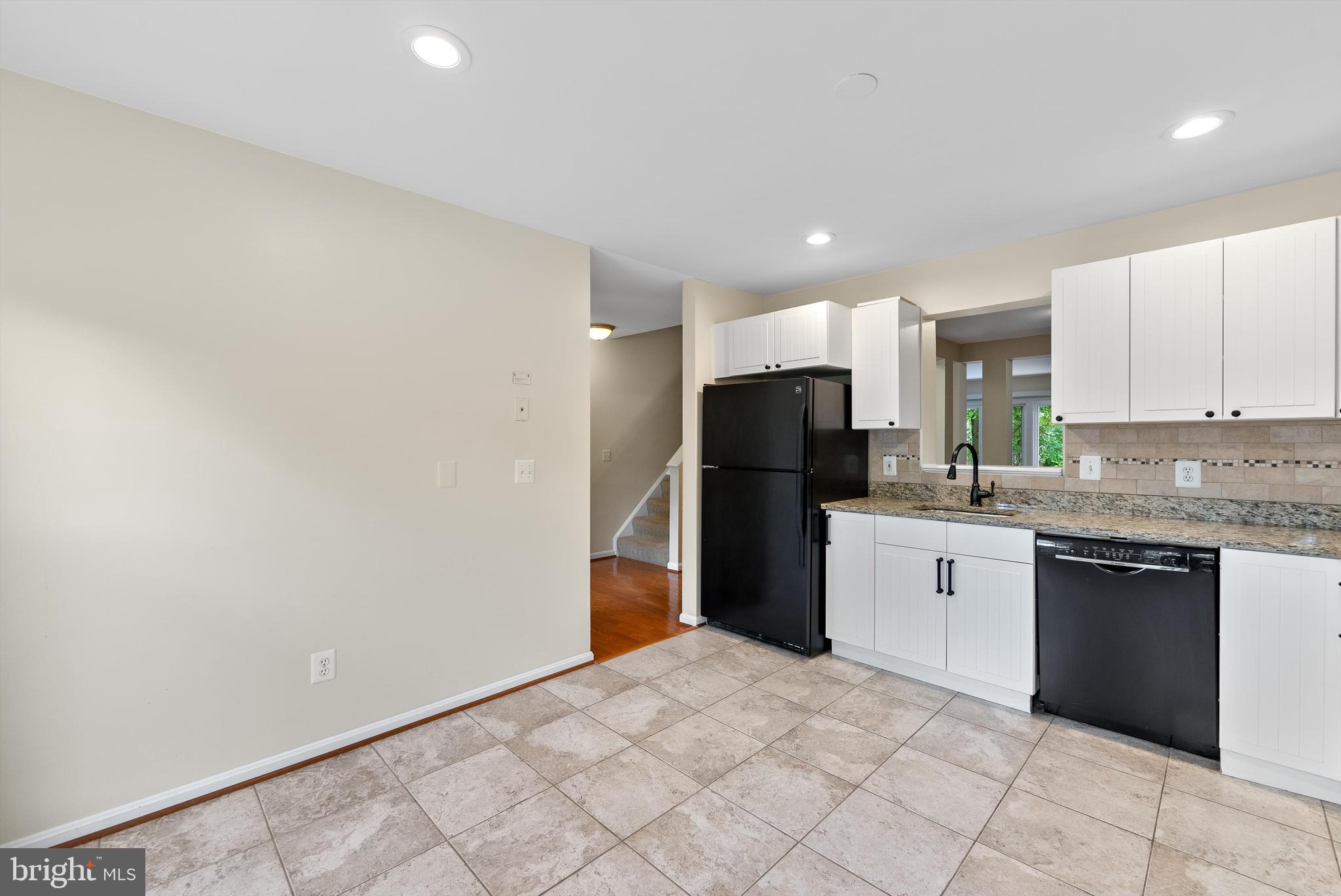 12081 Edgemere Circle Reston, VA 20190 - Photo 10 of 36 a kitchen with stainless steel appliances granite countertop a refrigerator a stove a sink and a microwave