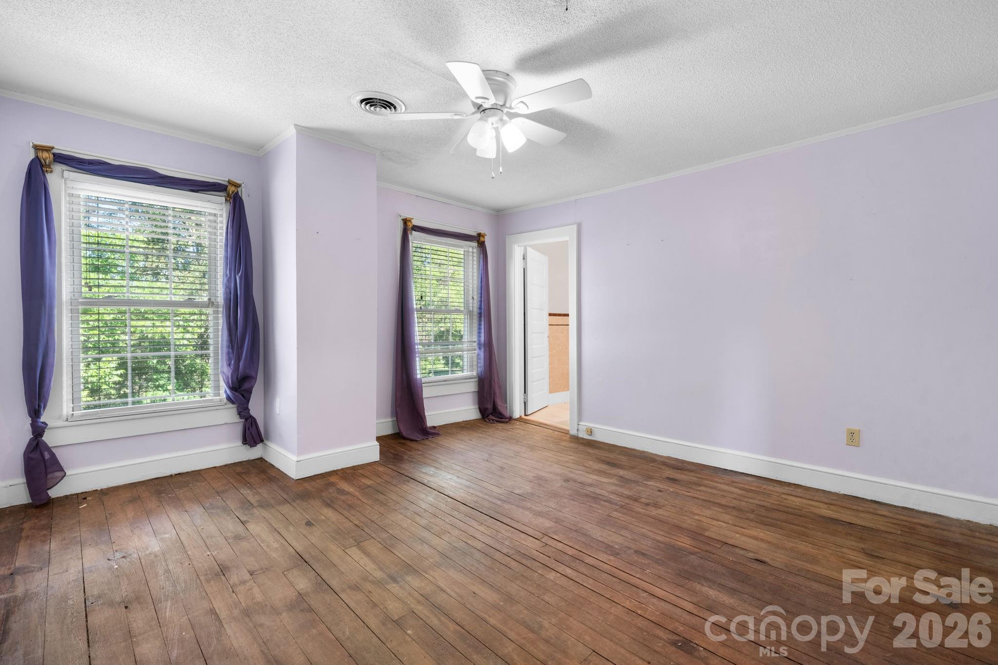144 Hunter Bridge Road Stony Point, NC 28678 - Photo 21 of 45 a view of an empty room with a window and wooden floor
