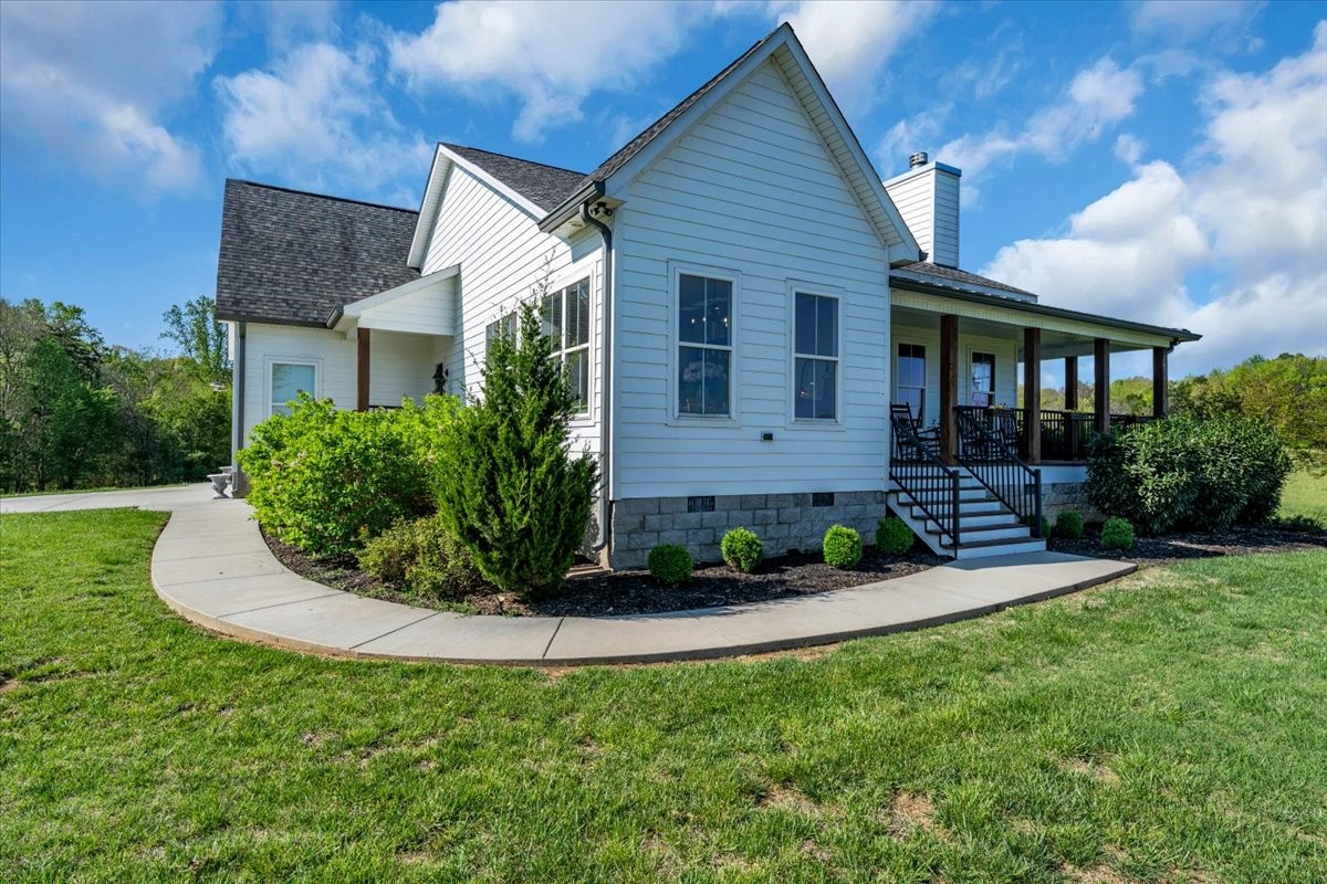 150 Edie Mae Lane Winchester, TN 37398 - Photo 2 of 79 a front view of a house with a yard and potted plants