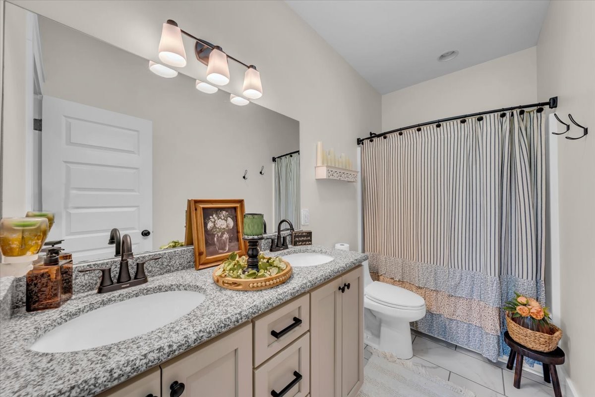 150 Edie Mae Lane Winchester, TN 37398 - Photo 22 of 79 a bathroom with a granite countertop sink a toilet and a mirror