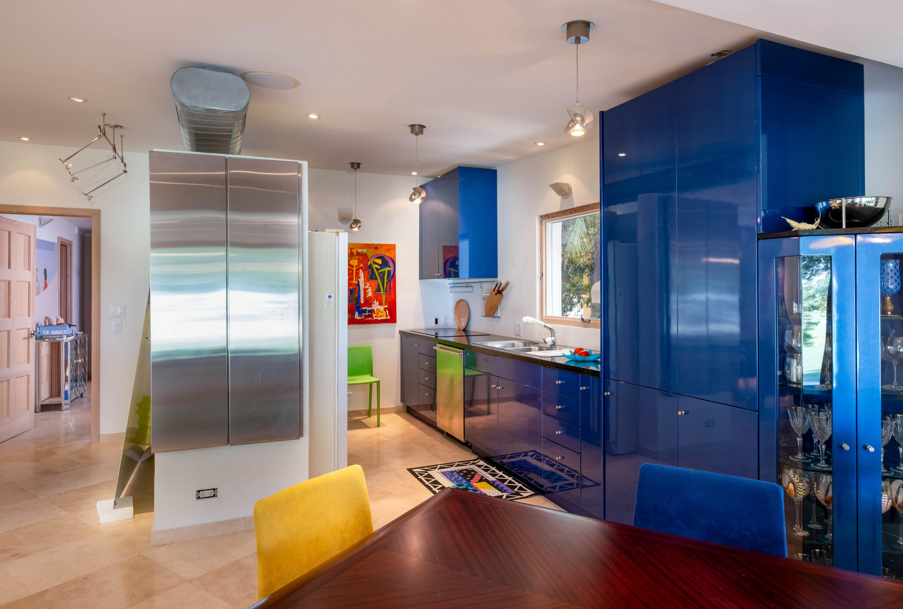 180 South Airport Road Tavernier, FL 33070 - Photo 11 of 33 a kitchen with stainless steel appliances kitchen island granite countertop a refrigerator a stove and a wooden cabinets with wooden floor