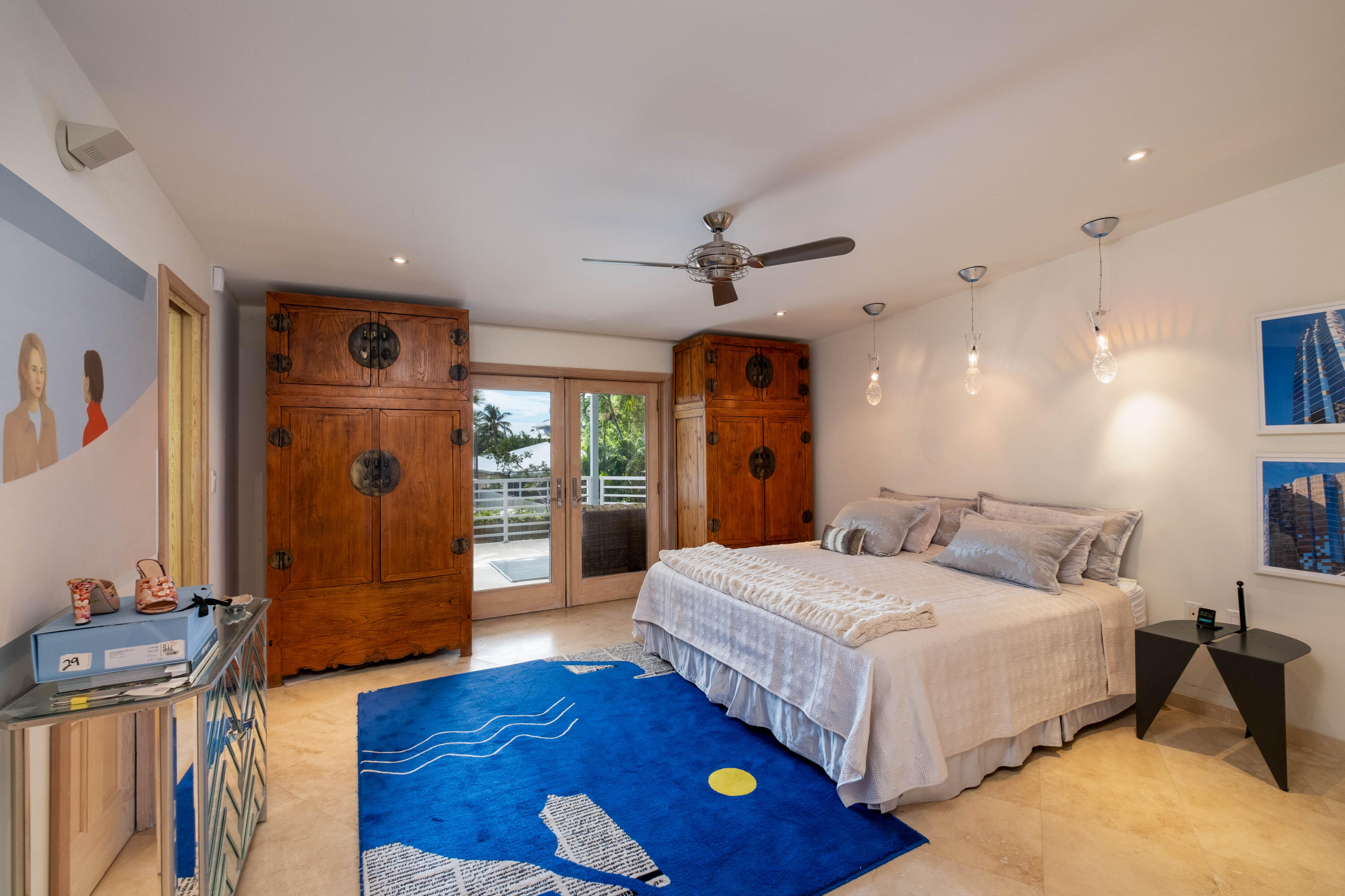 180 South Airport Road Tavernier, FL 33070 - Photo 18 of 33 a bedroom with a bed and a wooden floor