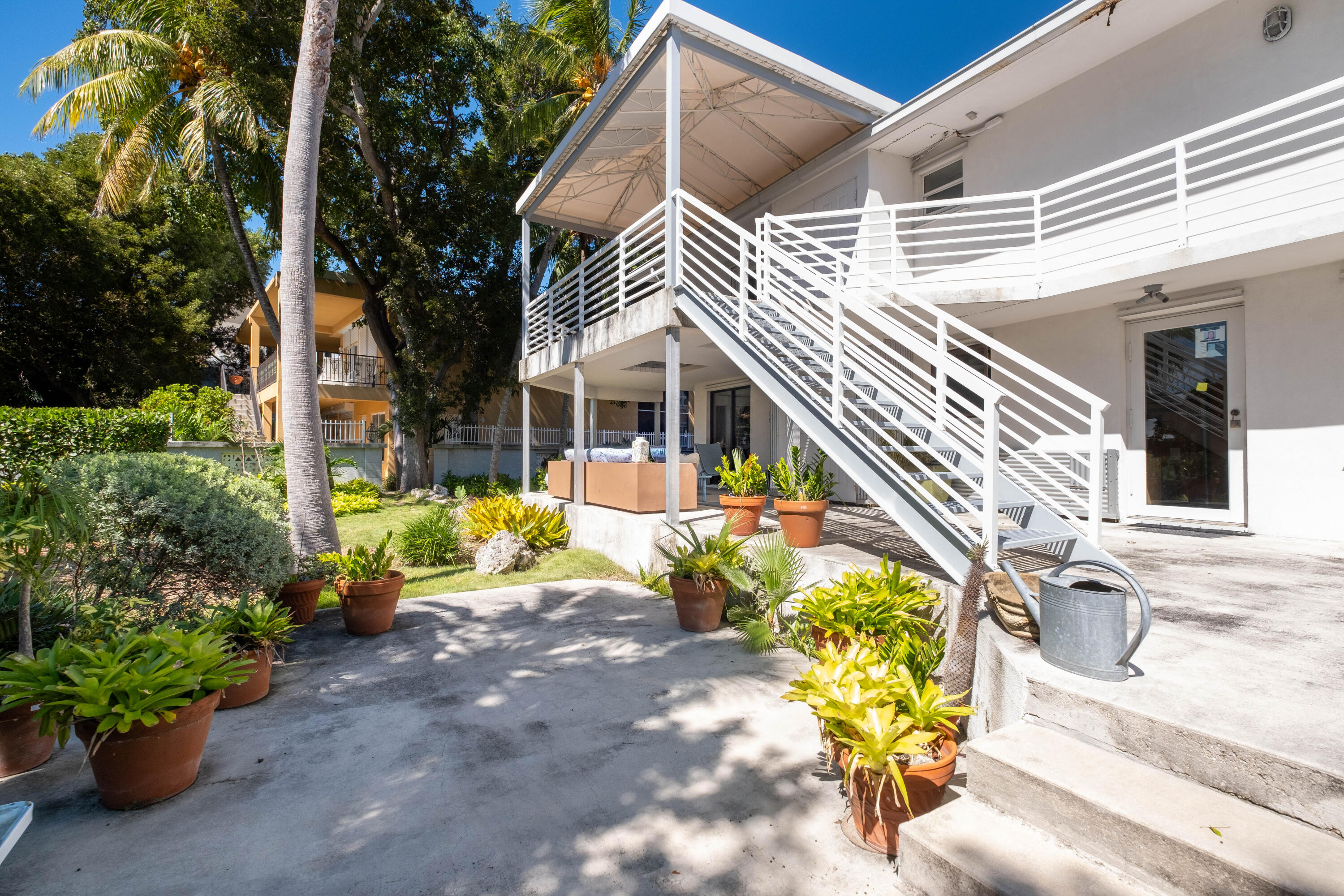 180 South Airport Road Tavernier, FL 33070 - Photo 24 of 33 a view of a house with chairs and flower plants