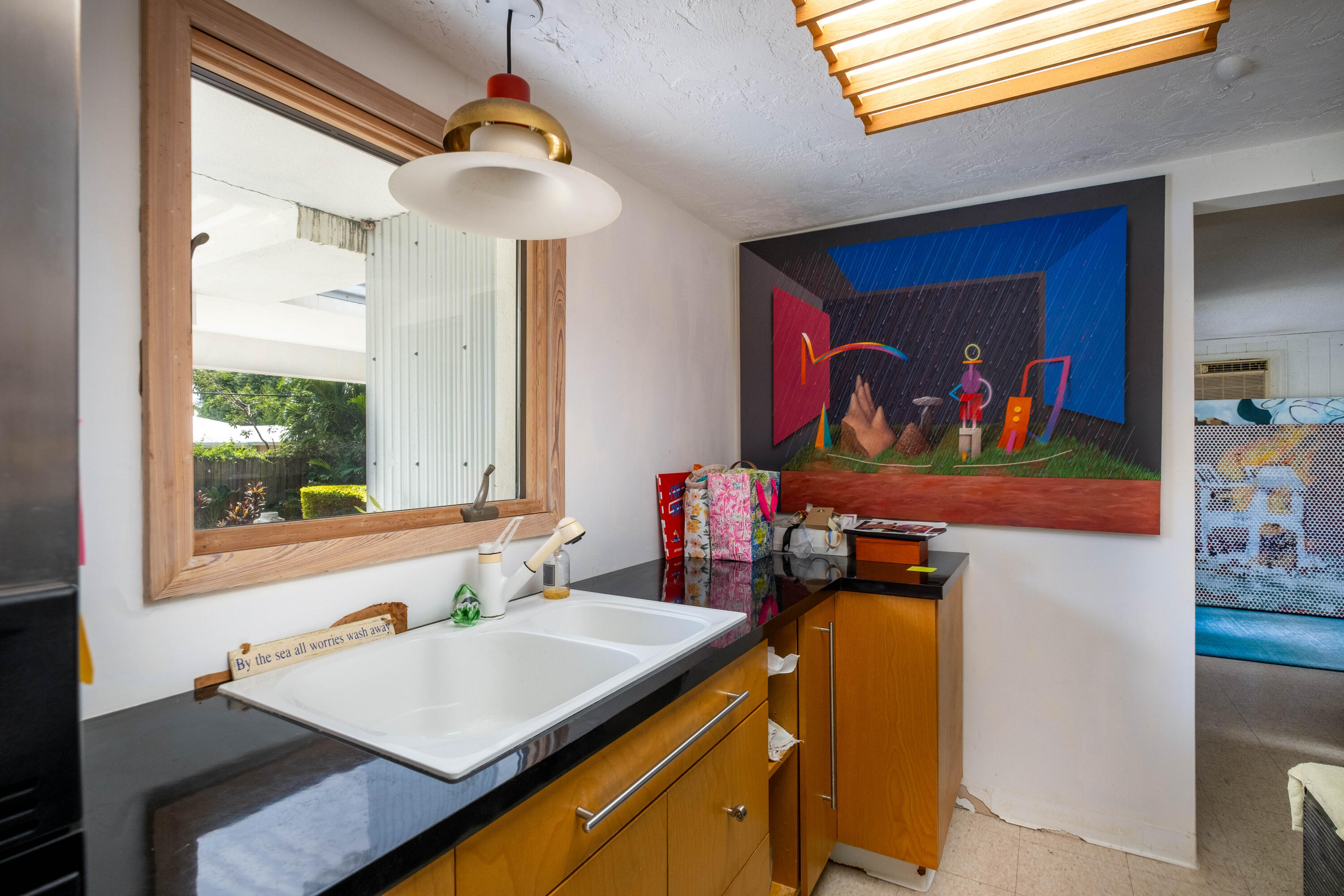 180 South Airport Road Tavernier, FL 33070 - Photo 27 of 33 a view of a kitchen with a sink and a refrigerator