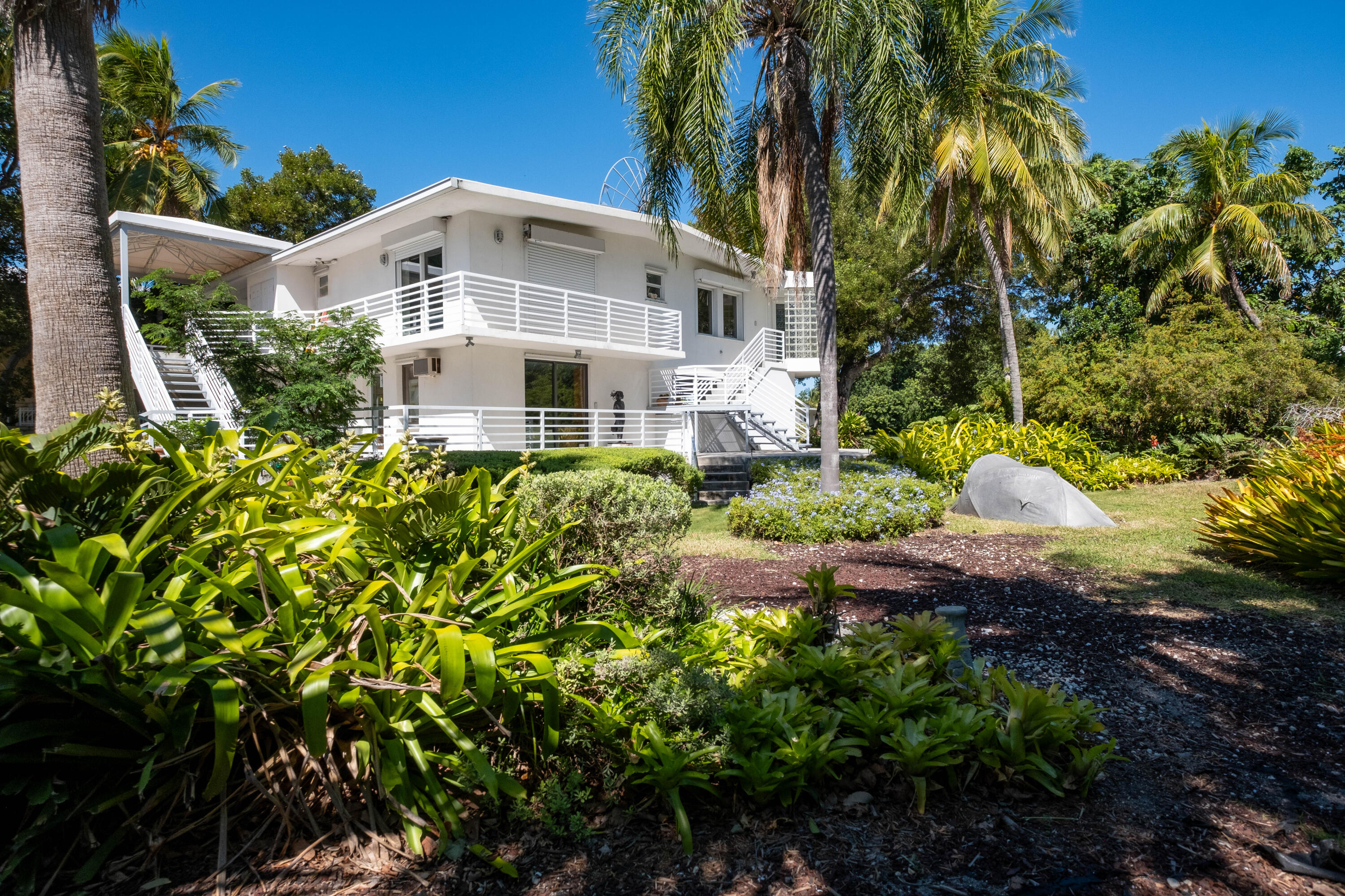 180 South Airport Road Tavernier, FL 33070 - Photo 28 of 33 a front view of a house with a yard and shrubs