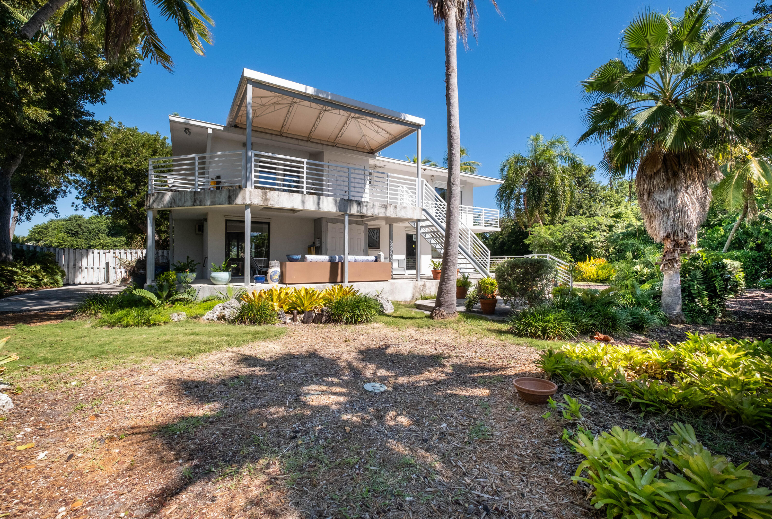 180 South Airport Road Tavernier, FL 33070 - Photo 29 of 33 a front view of a house with a yard and a garage