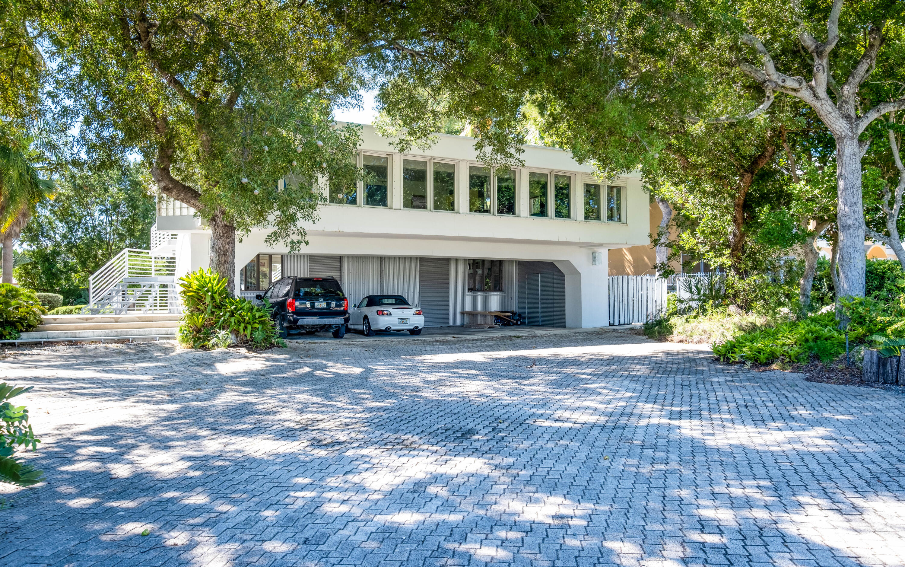 180 South Airport Road Tavernier, FL 33070 - Photo 5 of 33 a front view of a house with a yard and trees