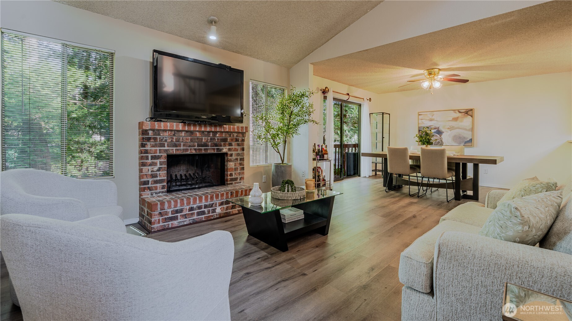 31732 47th Lane Southwest, Unit C Federal Way, WA 98023 - Photo 19 of 27 a living room with furniture a flat screen tv and a fireplace