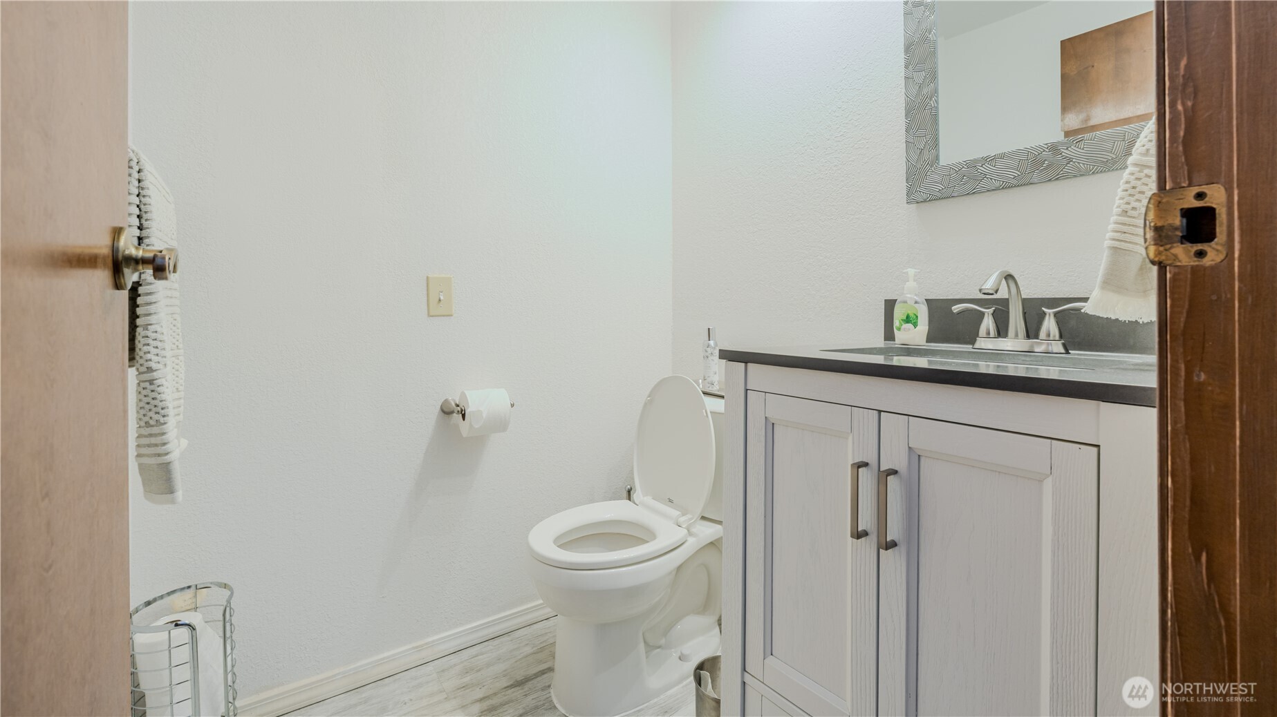 31732 47th Lane Southwest, Unit C Federal Way, WA 98023 - Photo 4 of 27 a bathroom with a granite countertop toilet a sink a mirror and vanity