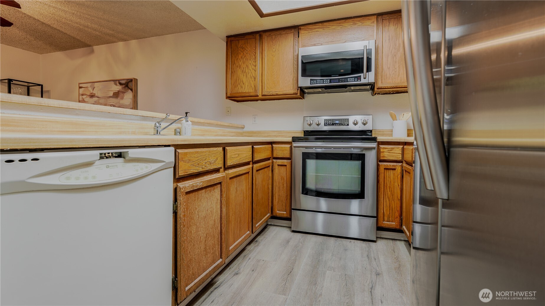 31732 47th Lane Southwest, Unit C Federal Way, WA 98023 - Photo 8 of 27 a kitchen with stainless steel appliances granite countertop a refrigerator and a stove