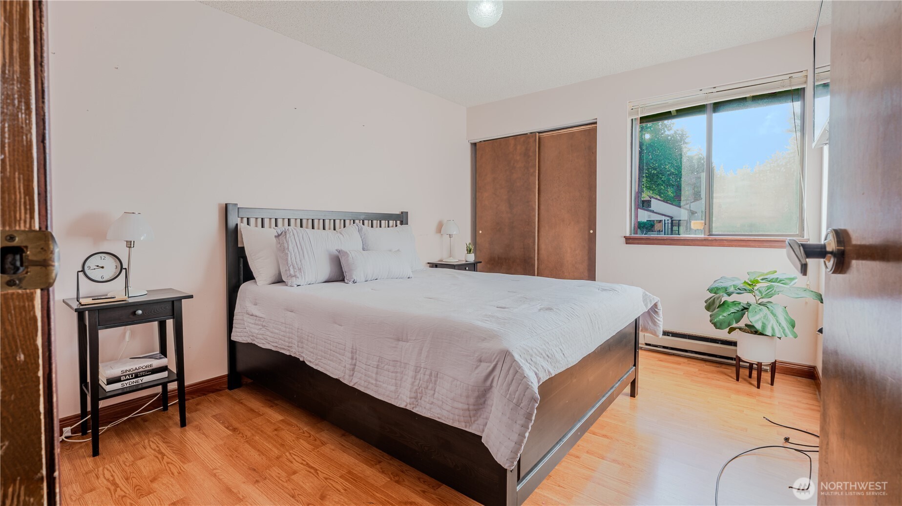 31732 47th Lane Southwest, Unit C Federal Way, WA 98023 - Photo 10 of 27 a bed sitting in a bedroom next to a window