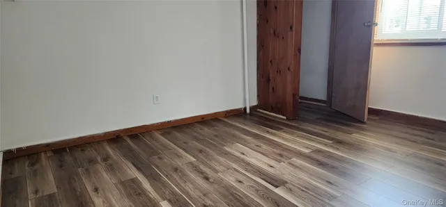 a view of a room with wooden floor