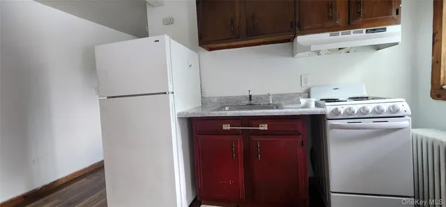 a white refrigerator freezer sitting inside of a kitchen