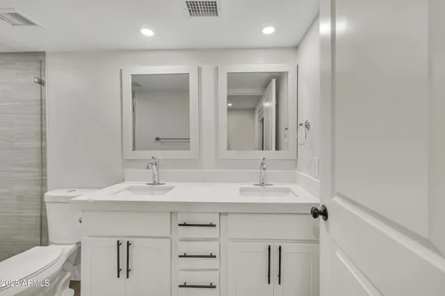 a bathroom with a sink vanity and a mirror