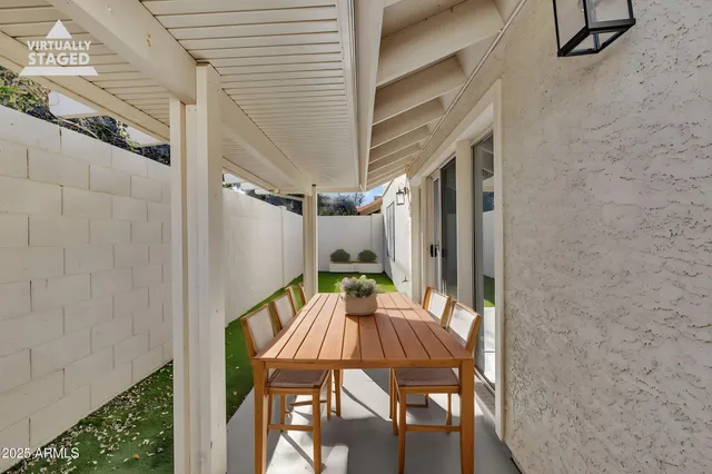a view of balcony with a table and chairs