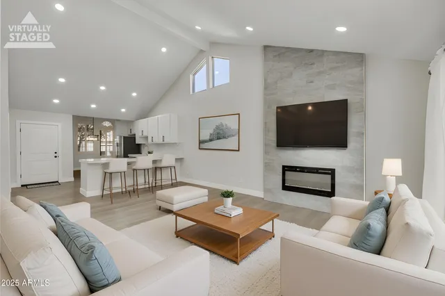 a living room with fireplace furniture and a flat screen tv
