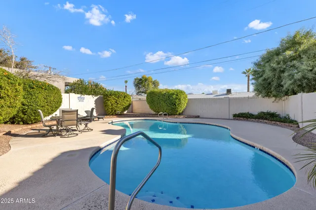 a view of a swimming pool with outdoor seating