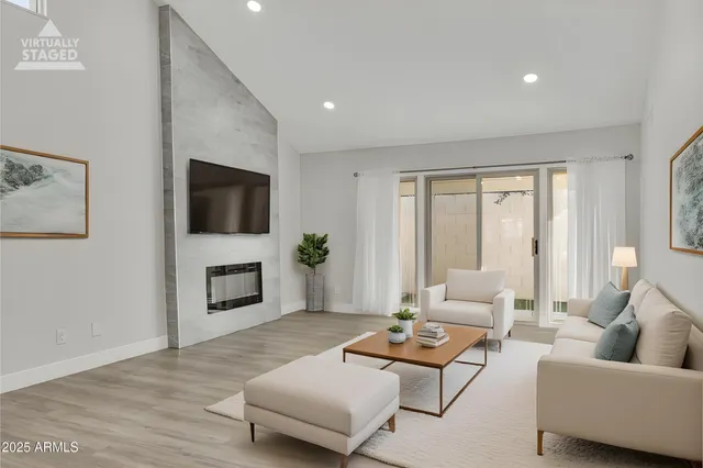 a living room with furniture flat screen tv and a fireplace