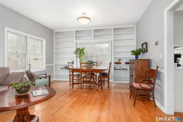 a living room with furniture and a wooden floor