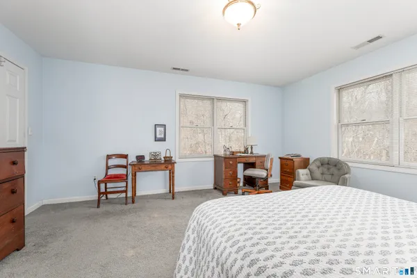 a bedroom with furniture and a window