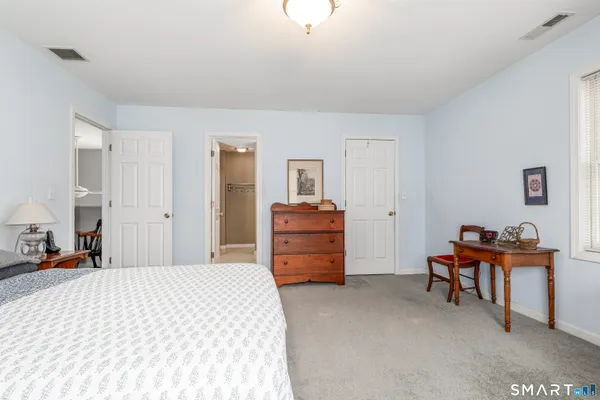 a bathroom with a sink a toilet and shower curtain