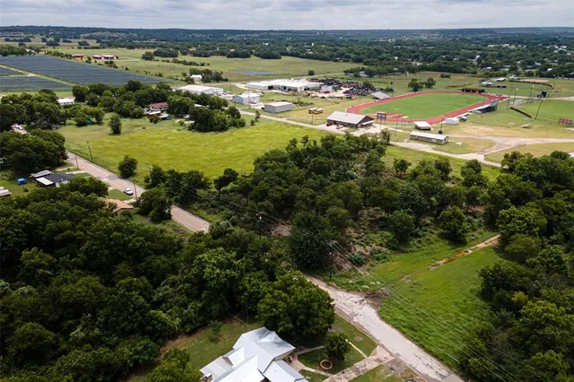 an aerial view of residential houses with outdoor space and river