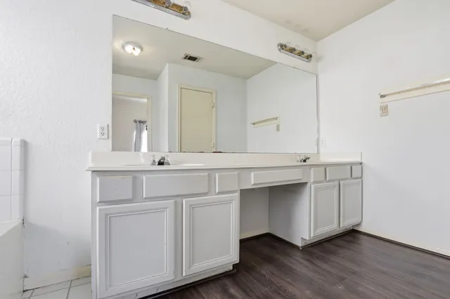 a bathroom with a double vanity sink and a mirror