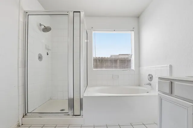 a bathroom with a bathtub and a shower